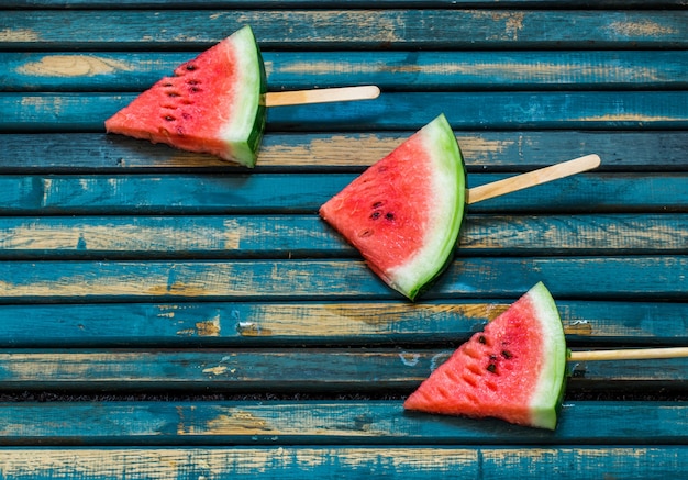 Delicious fresh watermelon. Ice cream with watermelon.  Delicious watermelon on a blue wooden background. Closeup. Place for text.