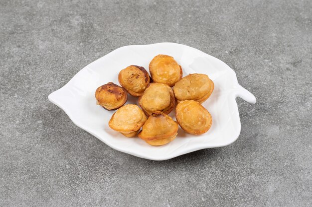 Delicious fried dumplings on white plate