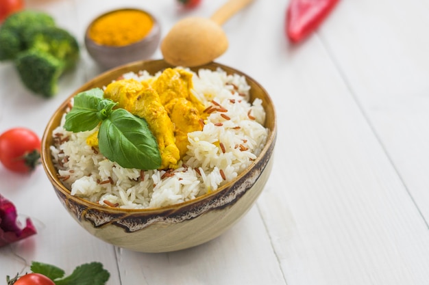 Free Photo delicious fried rice with basil leaves and chicken over white surface