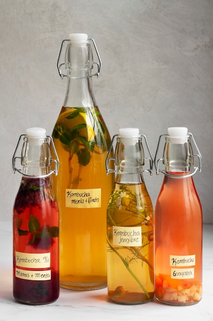 Free photo delicious fruits kombucha bottles still life