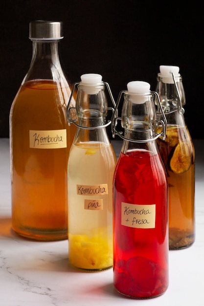 Free photo delicious fruits kombucha bottles still life