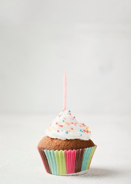 Delicious glazed muffin with candle