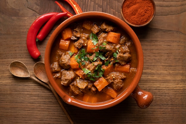 Delicious goulash stew on table