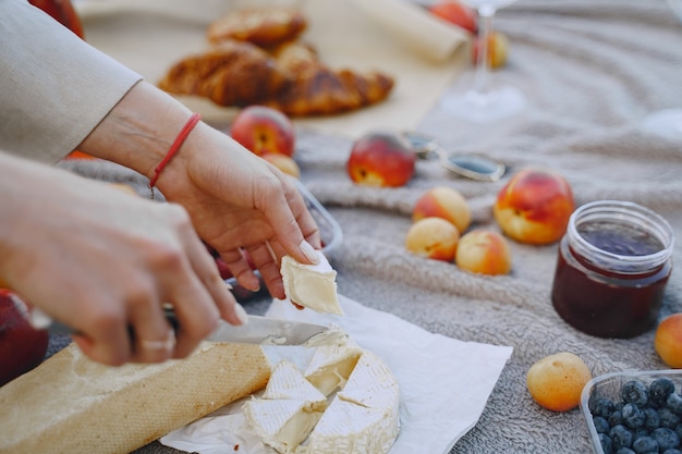 Free photo delicious healthy summer picnic on the grass. fruits on a blancet.