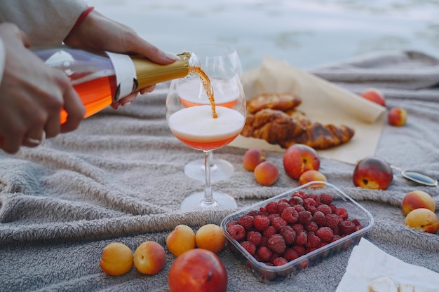 Free photo delicious healthy summer picnic on the grass. fruits on a blancet.