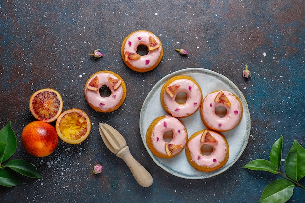 Free photo delicious homemade blood orange glaze donuts.