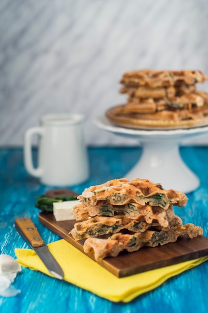 Free photo delicious homemade spicy waffle on wooden chopping board