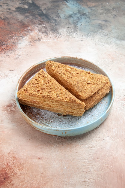 Free photo delicious honey cake inside tray on gray