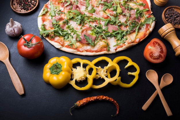 Free Photo delicious italian pasta with fresh ingredients and herbs on black backdrop