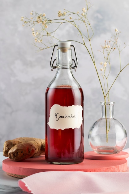 Free photo delicious kombucha bottle and ginger arrangement