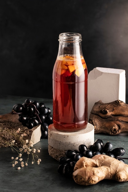 Free photo delicious kombucha bottle and grapes