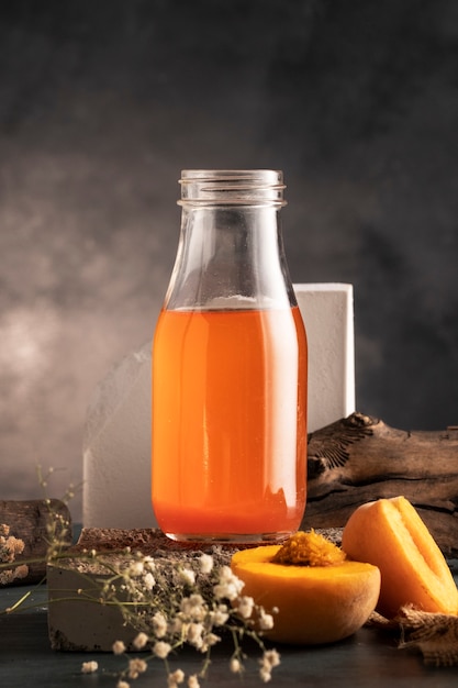 Free Photo delicious kombucha bottle and peach arrangement