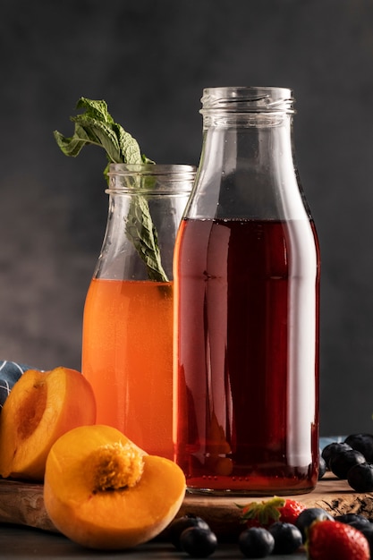 Free Photo delicious kombucha bottles and berries