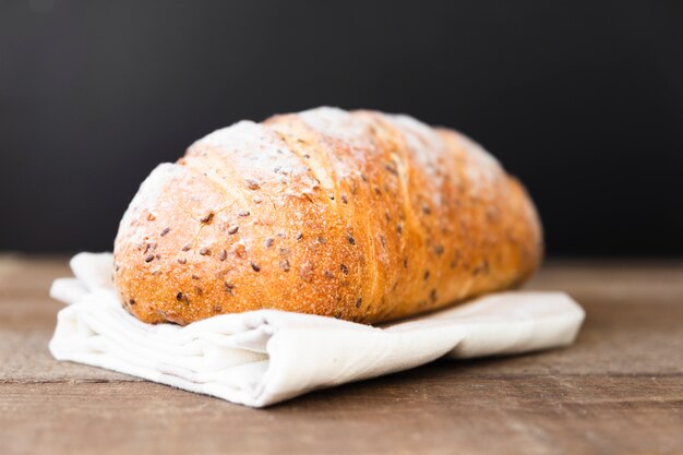 Delicious loaf of bread with seeds on the table