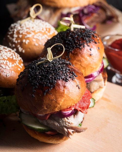 Delicious looking hamburgers on wooden board close-up