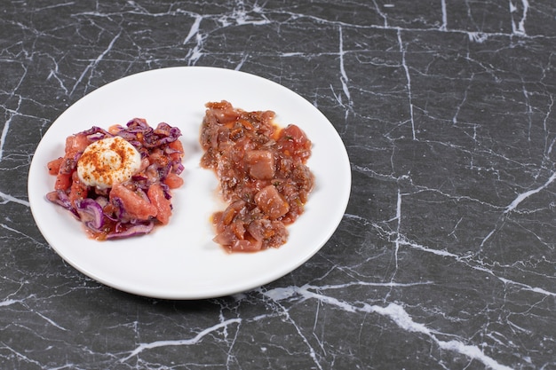 Free photo delicious meal with meat in a white plate on a marble.