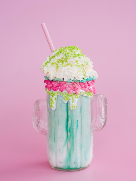 Delicious milkshake on pink background