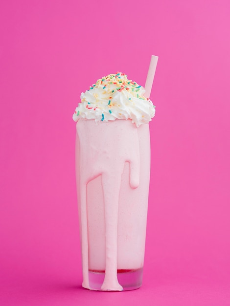 Free Photo delicious milkshake with pink background