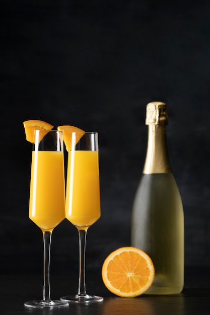 Free Photo delicious mimosa cocktail with dark background