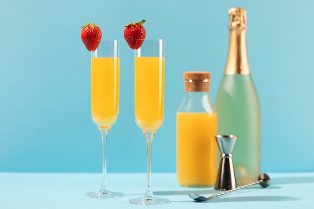 Free photo delicious mimosa tall glasses with strawberries