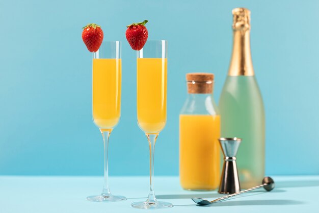 Delicious mimosa tall glasses with strawberries