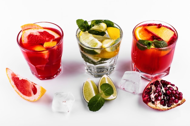 Delicious mojito, rum and cola, blood orange and vodka cocktails served with fruit