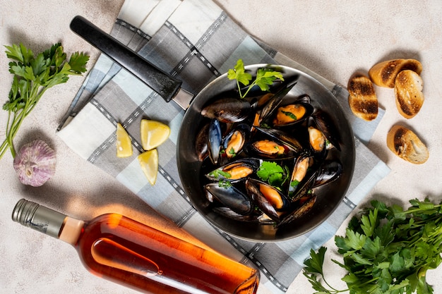 Delicious mussel shells with bottle of wine