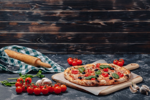 Delicious Neapolitan pizza on board with cherry tomatoes, free space for text