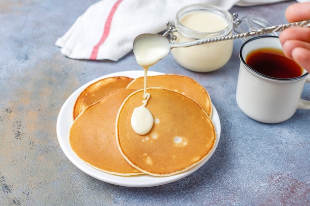 Free photo delicious pancakes with condensed milk.