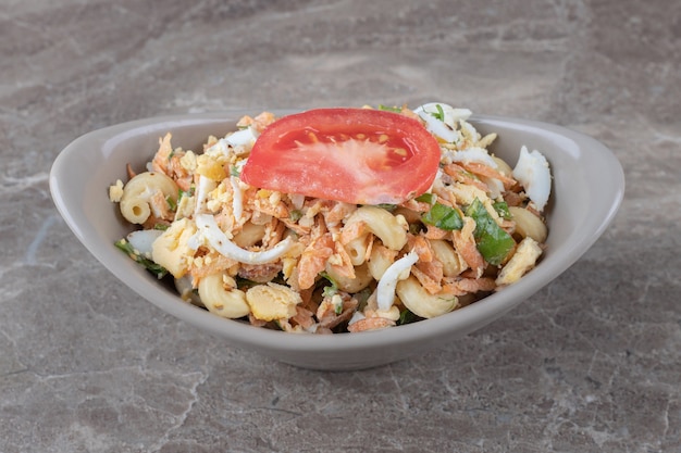 Delicious pasta with eggs in ceramic bowl.