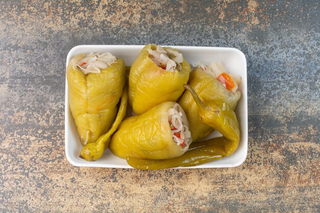 Delicious peppers with cabbage on white plate. High quality photo