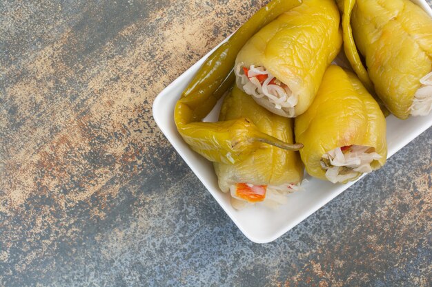 Delicious peppers with cabbage on white plate. High quality photo