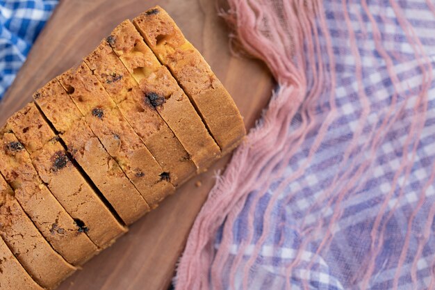 Delicious pie with multiple ingredients on a wooden cutting board