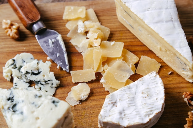 Delicious pieces of cheese wooden board