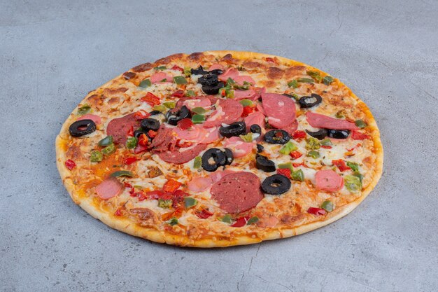 Delicious pizza displayed on marble background.