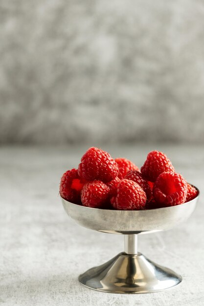 Delicious raspberries in bowl  arrangement