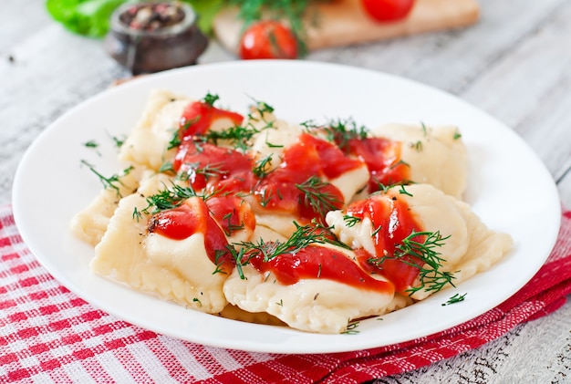 Free photo delicious ravioli with tomato sauce and dill