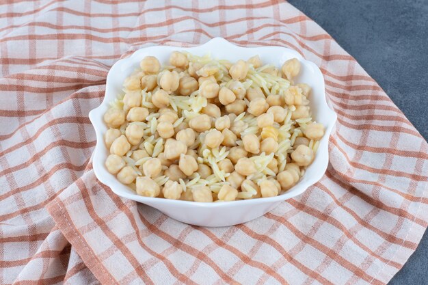 Delicious rice with chickpeas in white bowl.