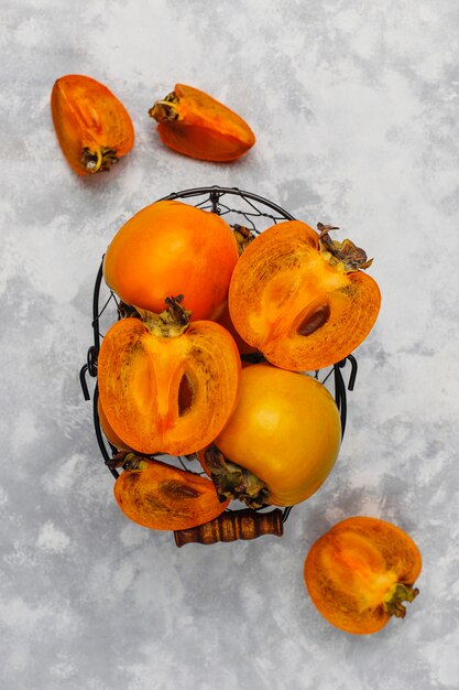 Delicious ripe persimmon fruit on concrete 