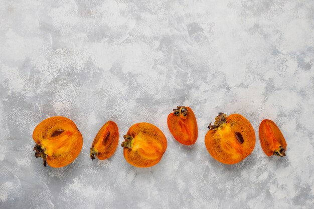 Delicious ripe persimmon fruit on concrete 