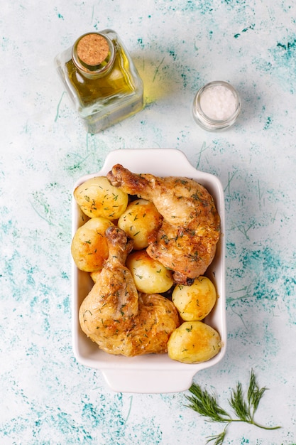 Free photo delicious roasted young potatoes with dill and chicken,top view