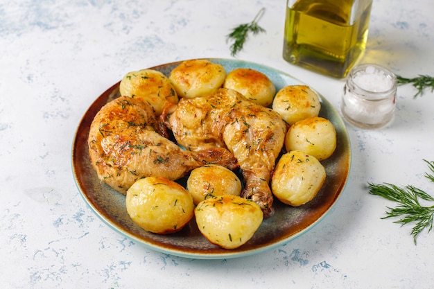 Free Photo delicious roasted young potatoes with dill and chicken, top view