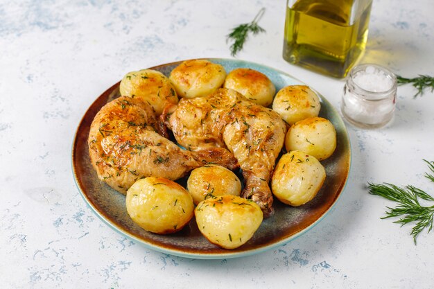 Delicious roasted young potatoes with dill and chicken, top view