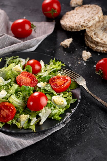 Delicious salad on dark plate