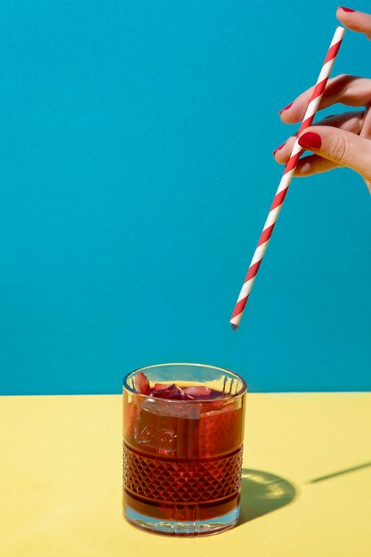 Delicious sangria in glass on yellow surface