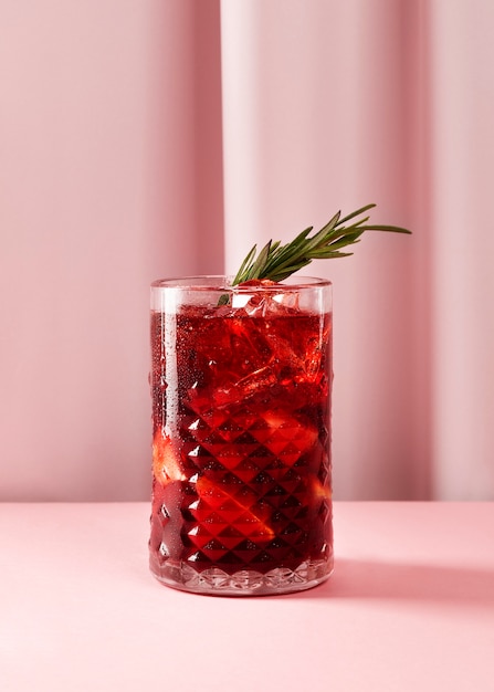 Delicious sangria with herbs and pink background