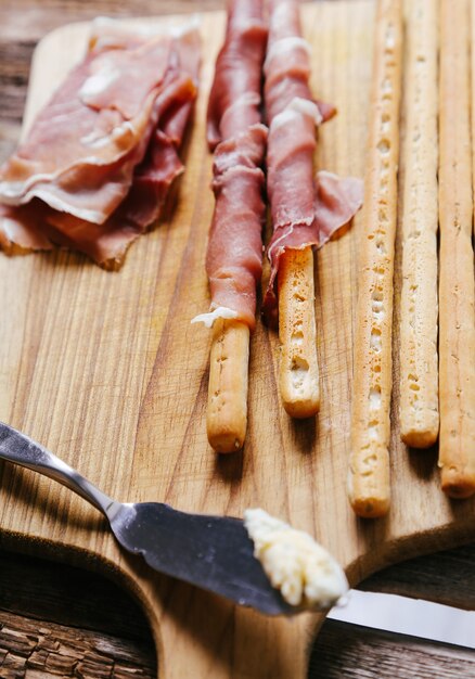 Delicious snacks on wooden board