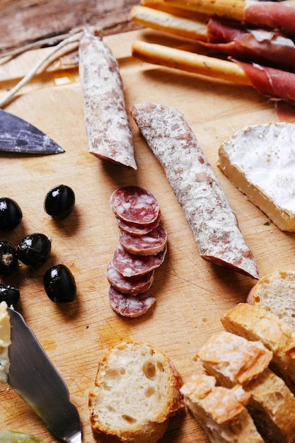 Delicious snacks on wooden board