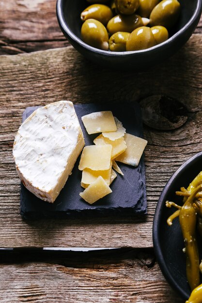 Delicious snacks on wooden board