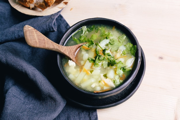 Delicious soup on black bowl